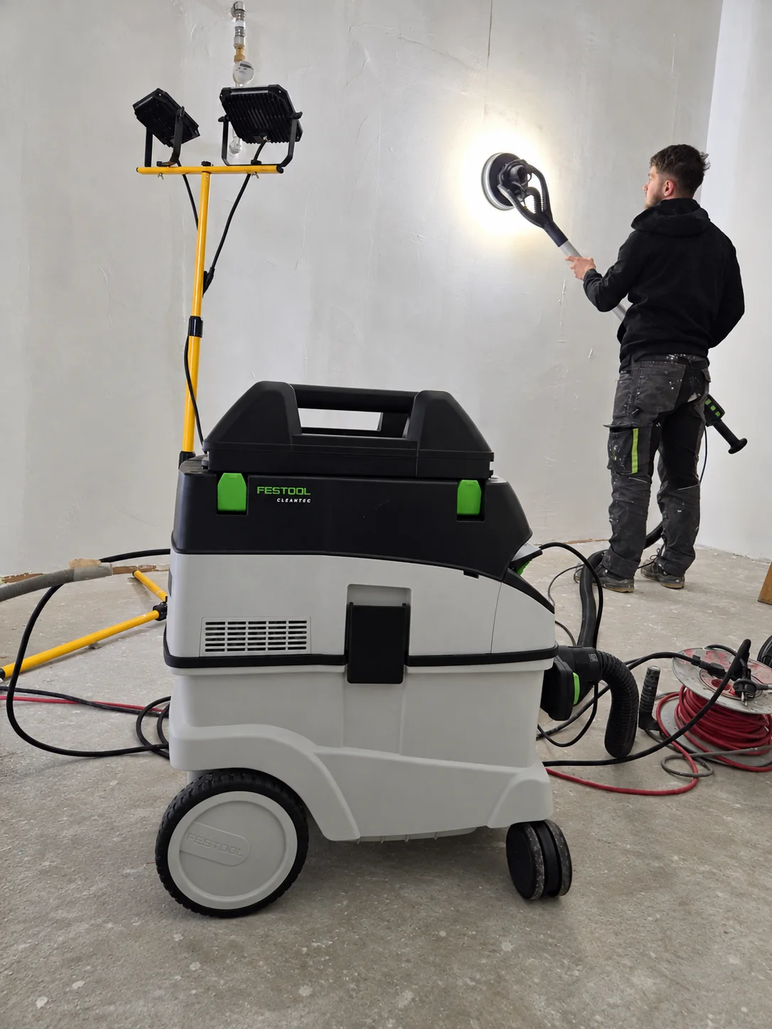 Sanding and preparing an interior wall at Starše Library